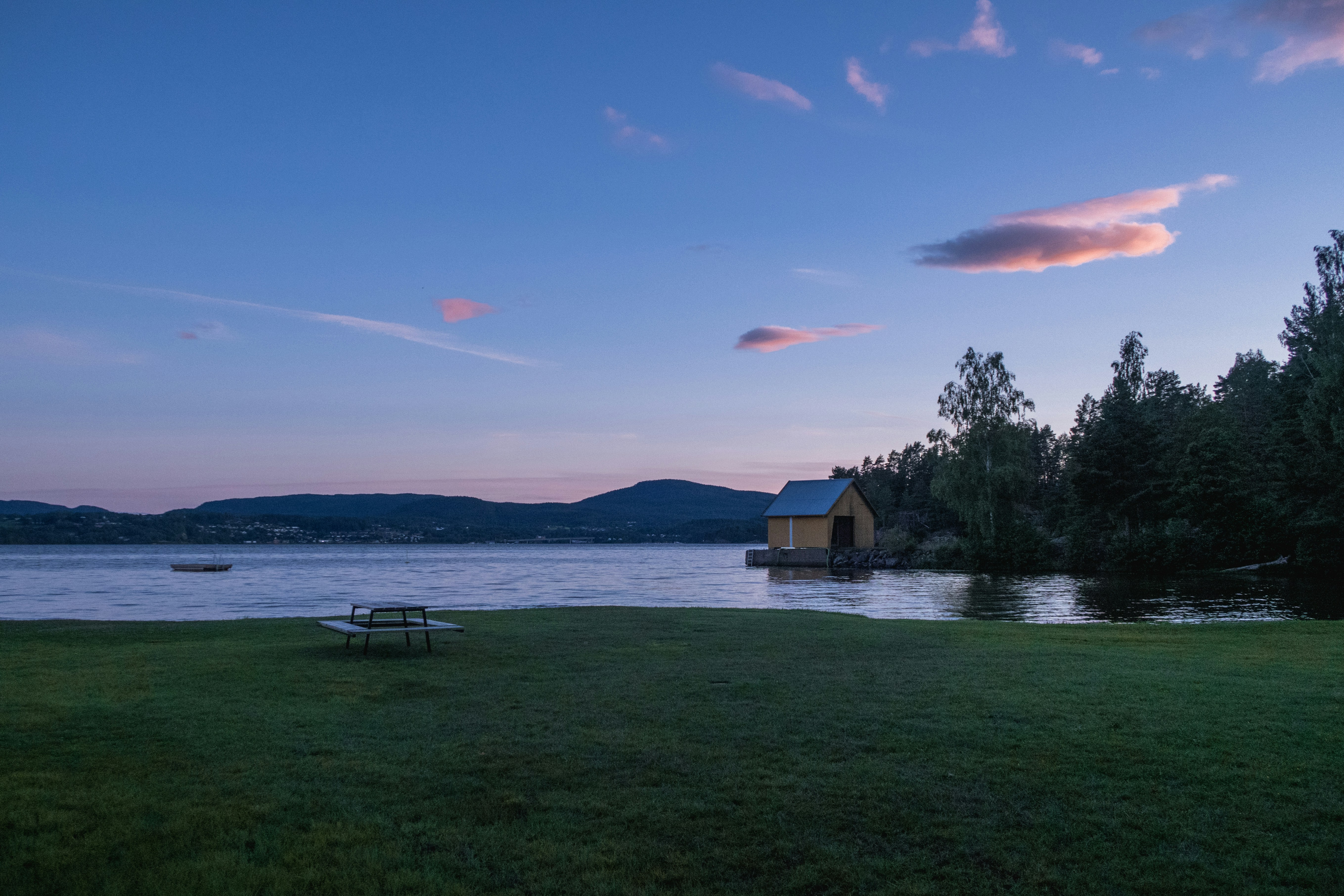a lake with a picnic table next to it