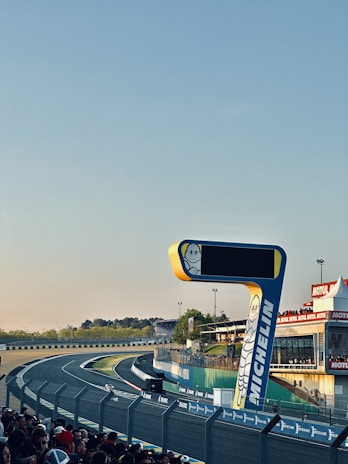 Photo of a branded event organized by Lacouronne Services with sponsors and fans.