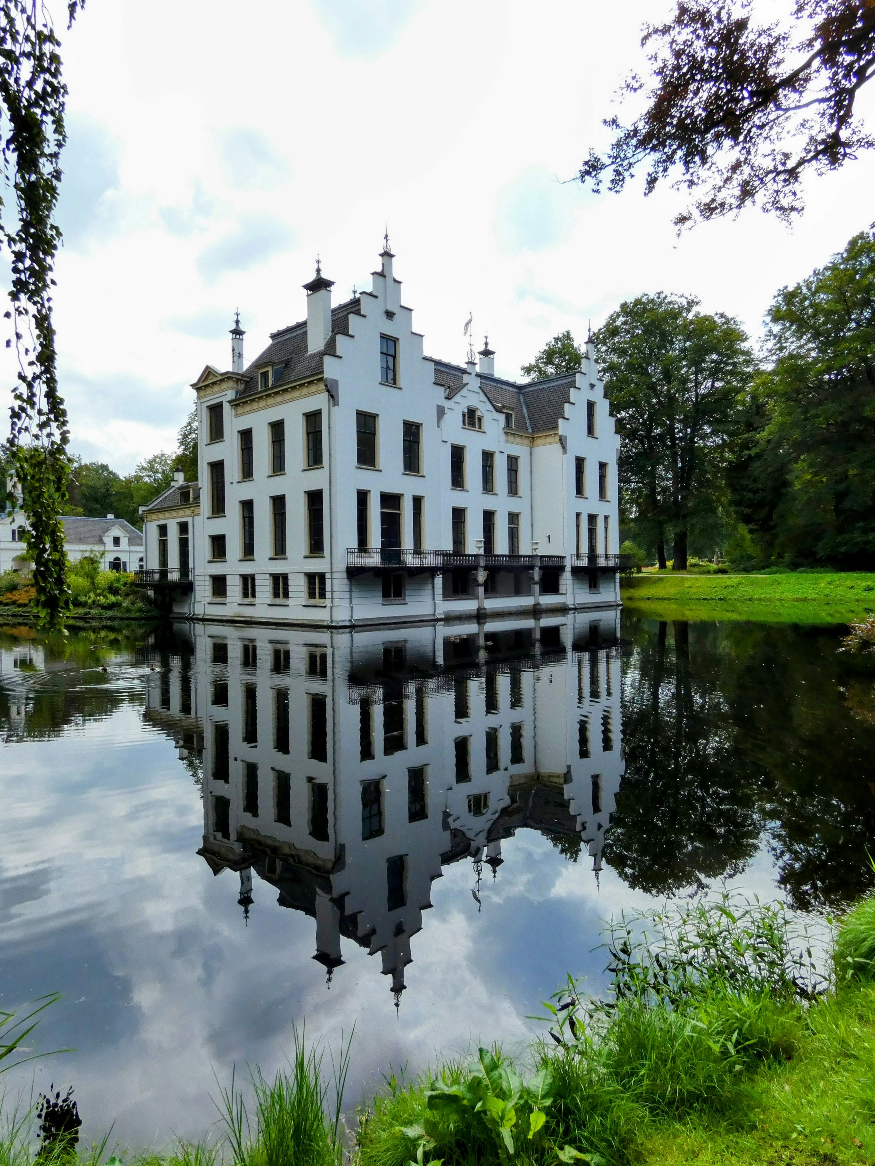 a large white building sitting on top of a lake