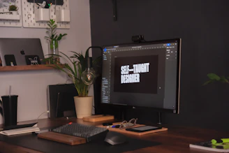 A calm designer adjusting a website on a laptop, surrounded by notes and plants.
