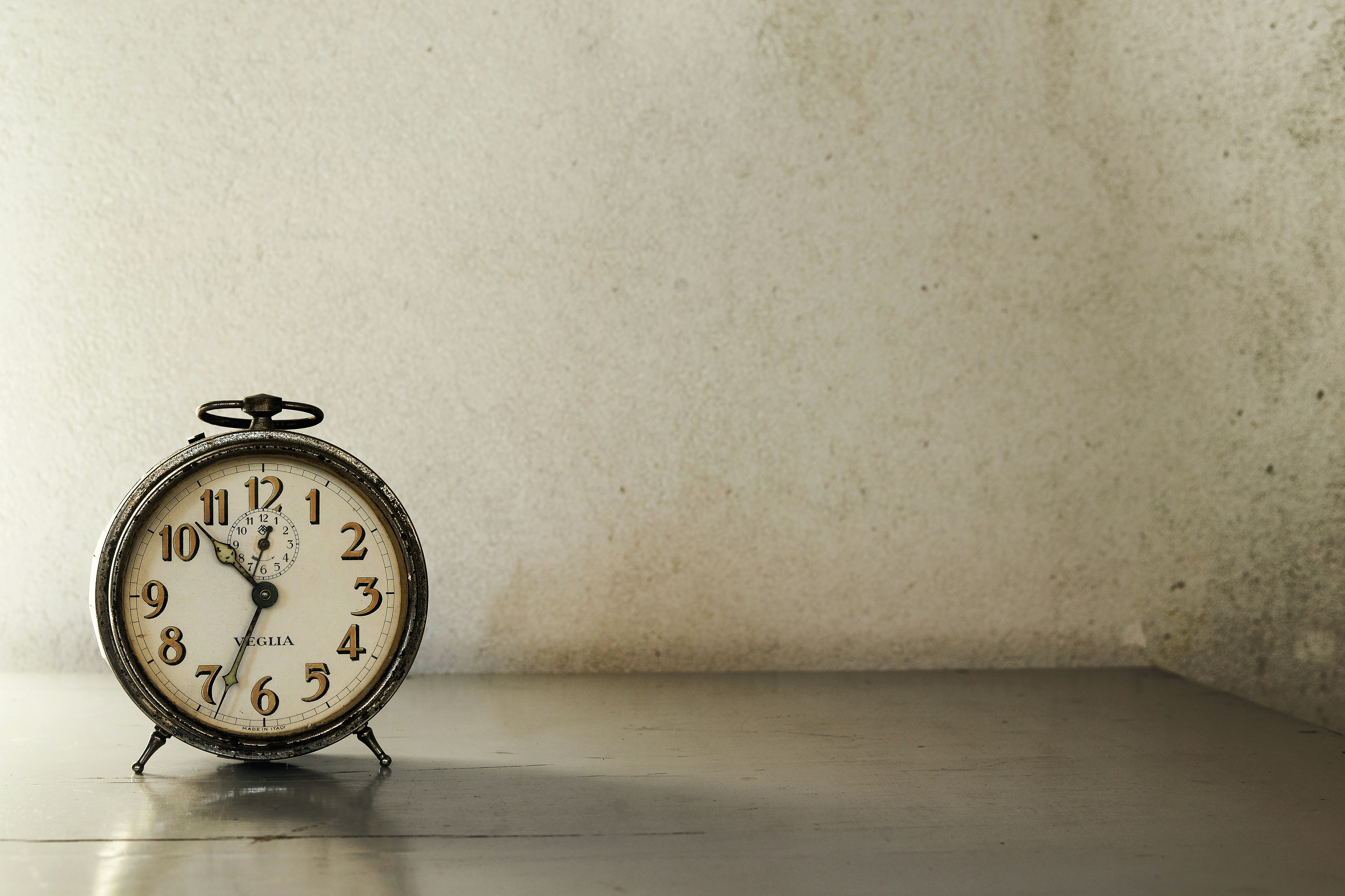 a clock sitting on top of a metal table