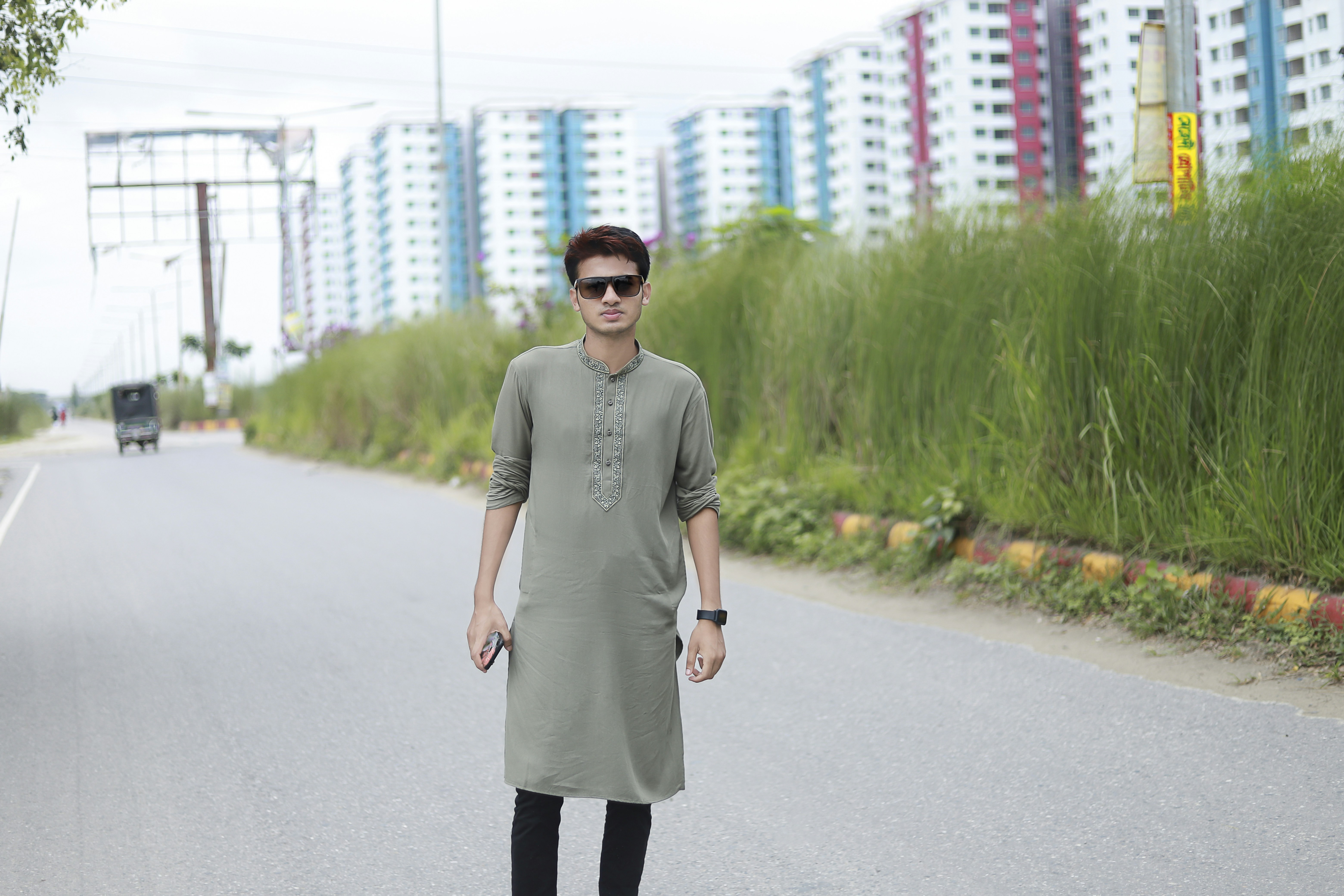 a man standing on the side of a road
