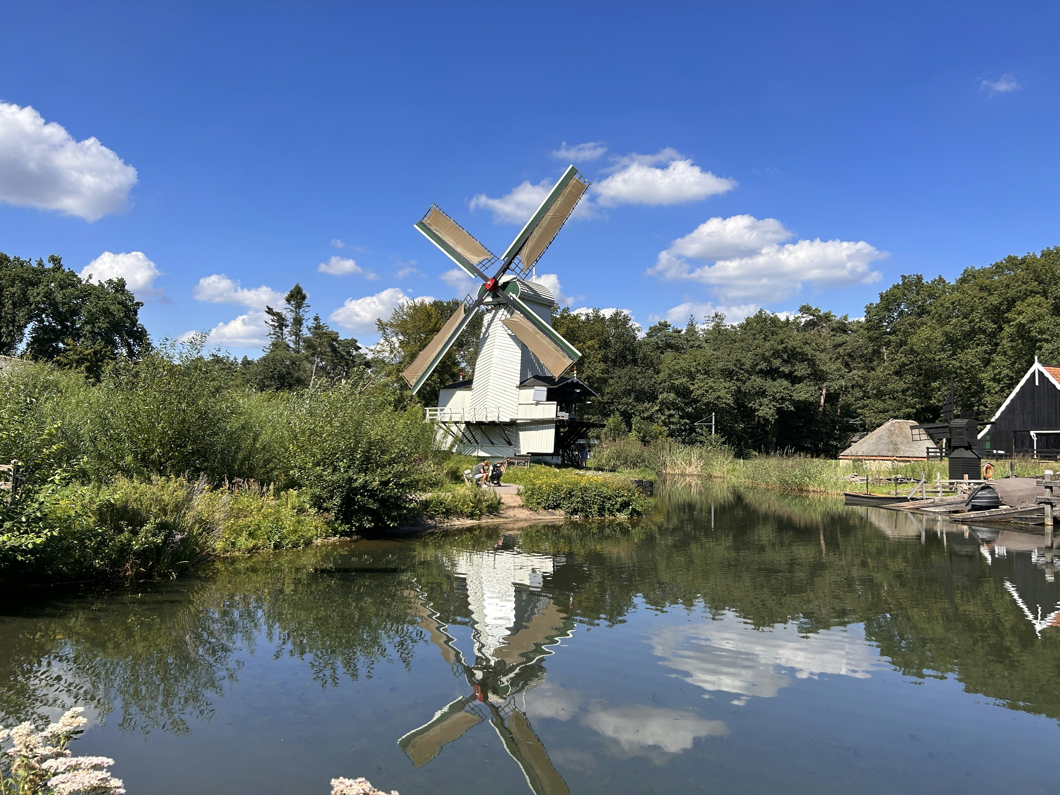 a windmill sitting next to a body of water