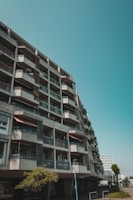 Wide shot of a mid-rise residential building showcasing exposed concrete columns and beams.
