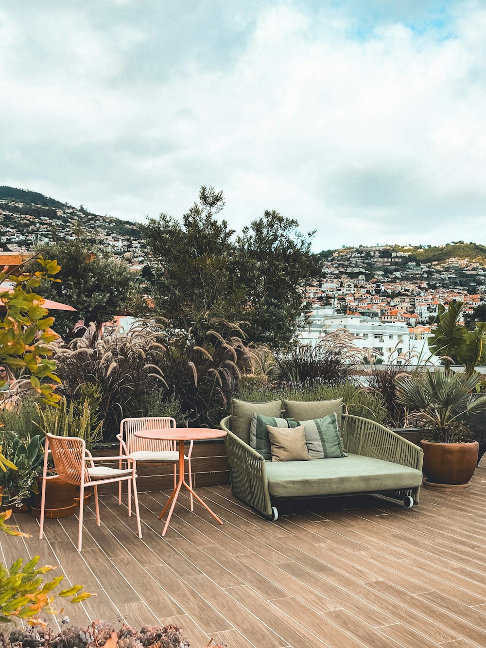 a patio with a couch, table and chairs