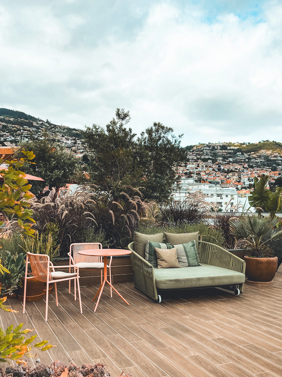 Garden terrace in Madeira with comfortable outdoor seating, lush plants and hillside views