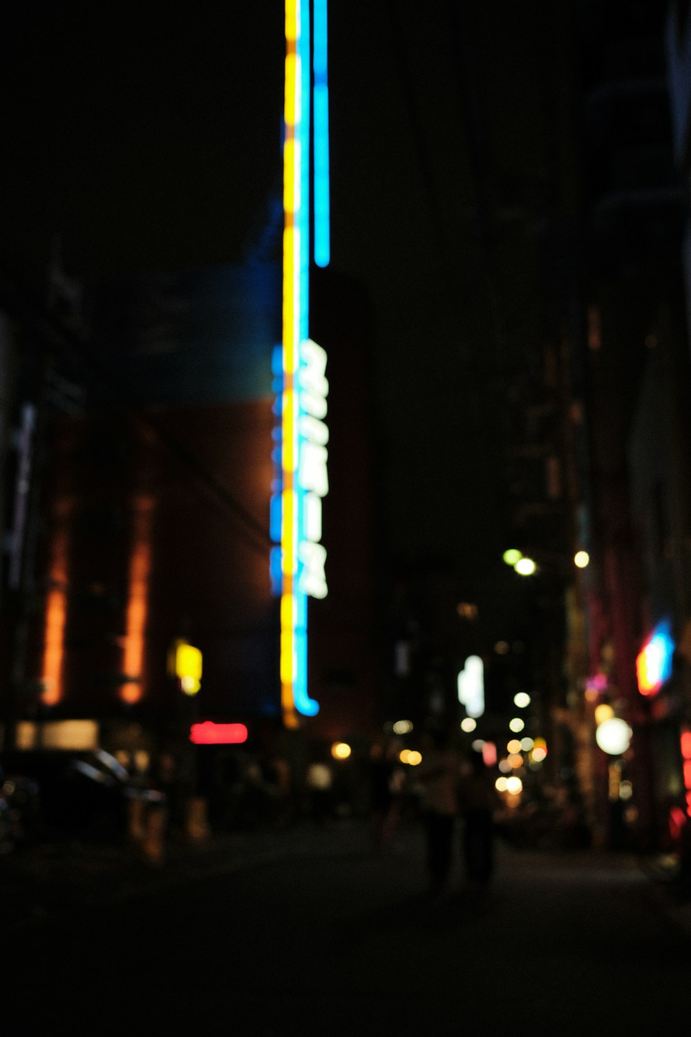 a person walking down a street at night