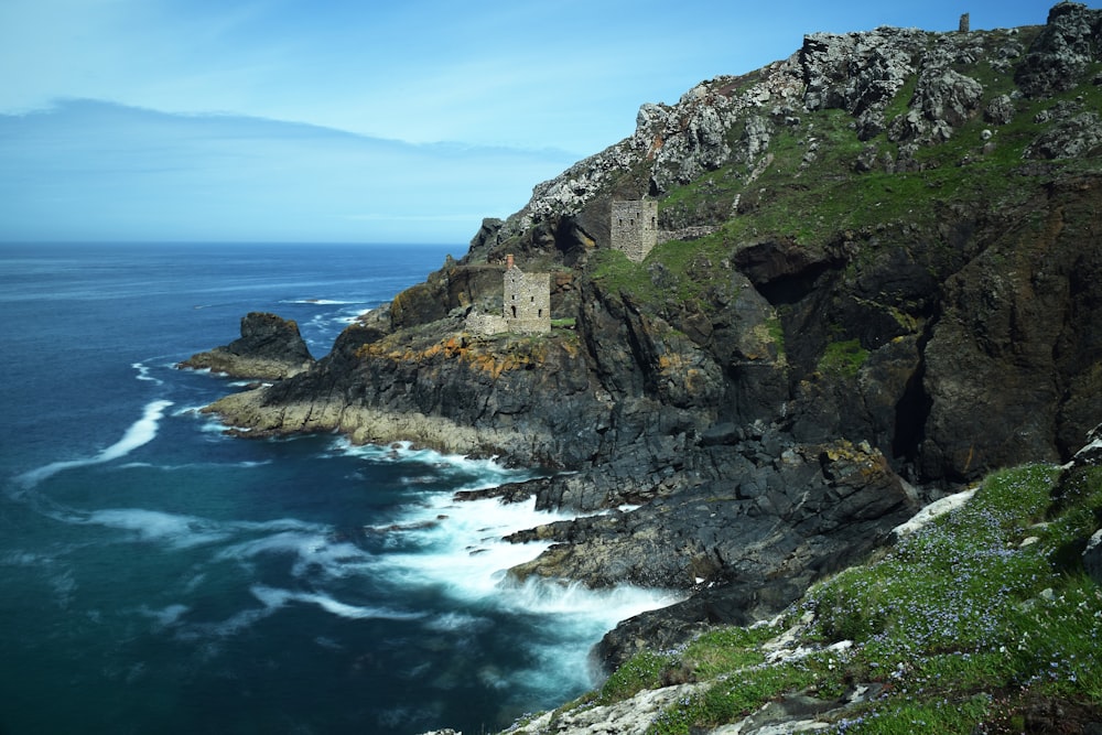 a castle on a cliff overlooking the ocean