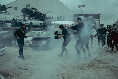 a group of people standing around in a parking lot