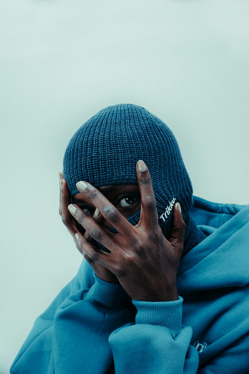 a woman covering her face with her hands