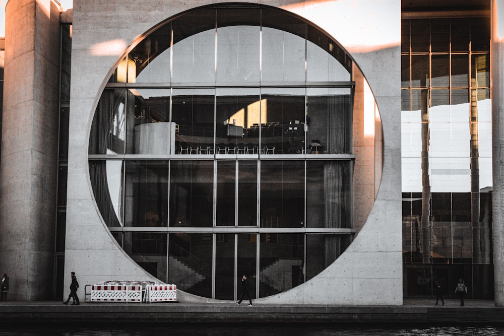 a building with a circular window and a boat in front of it