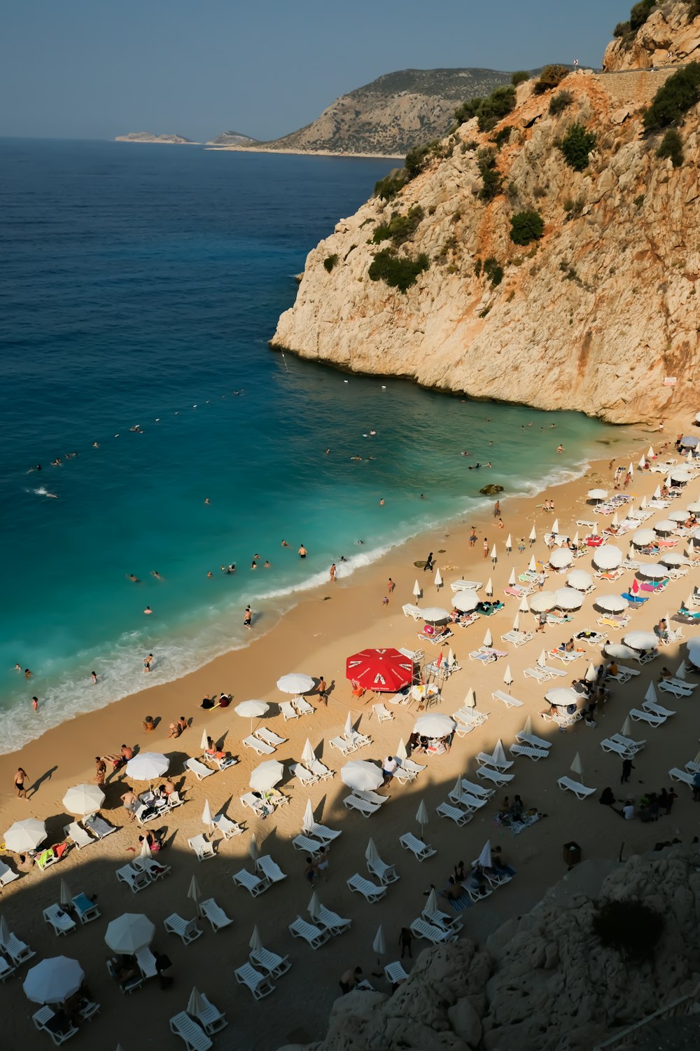 a group of people on a beach with umbrellas