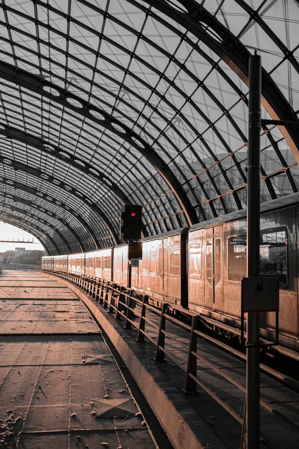 a train traveling through a train station next to a traffic light