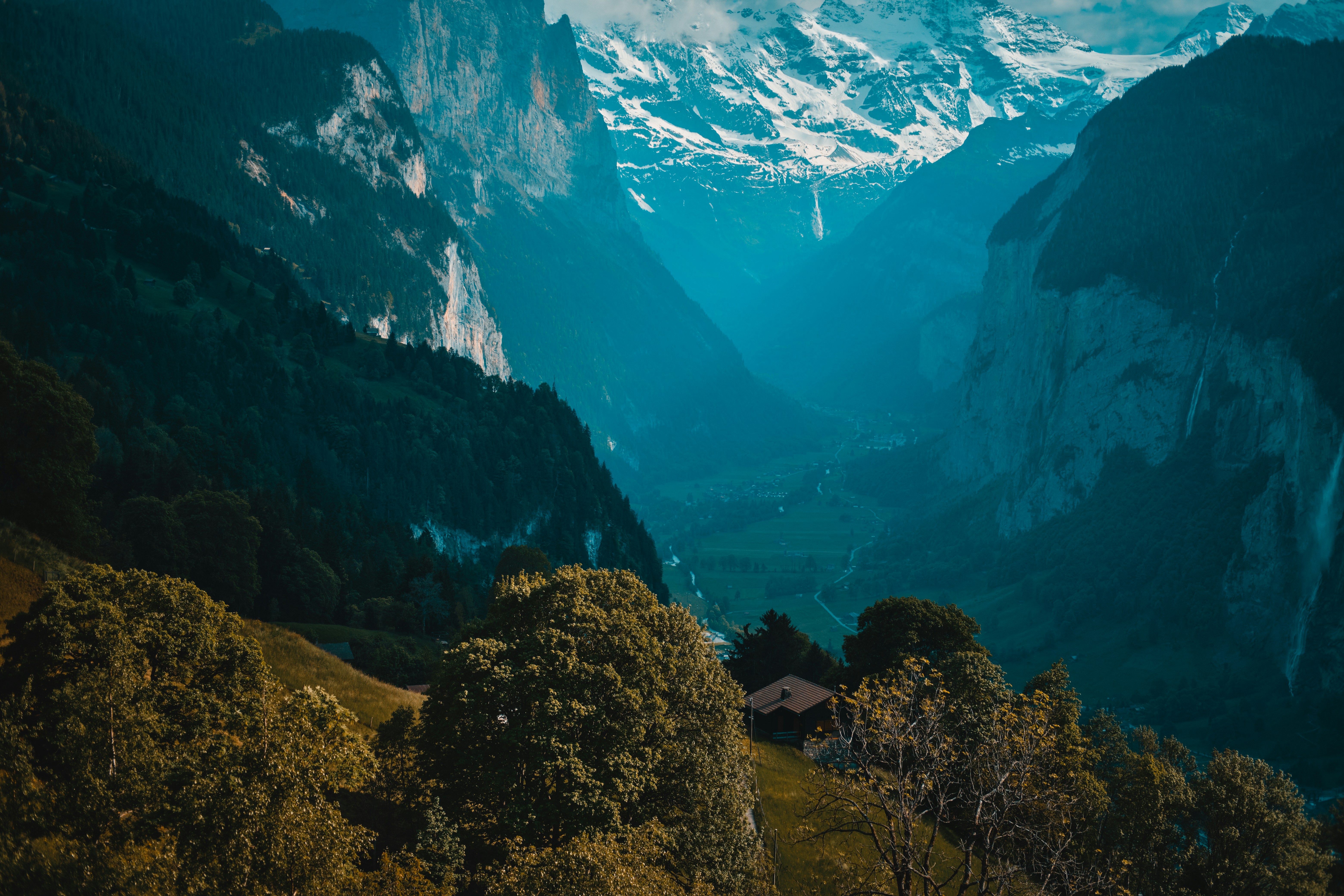 a view of a mountain range with a house in the foreground