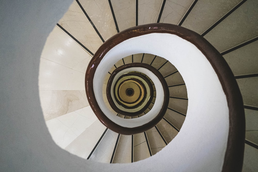 a spiral staircase in a building with white walls