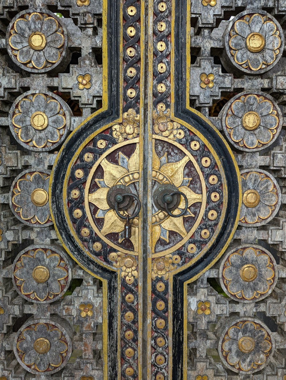 a close up of a metal door with a clock on it