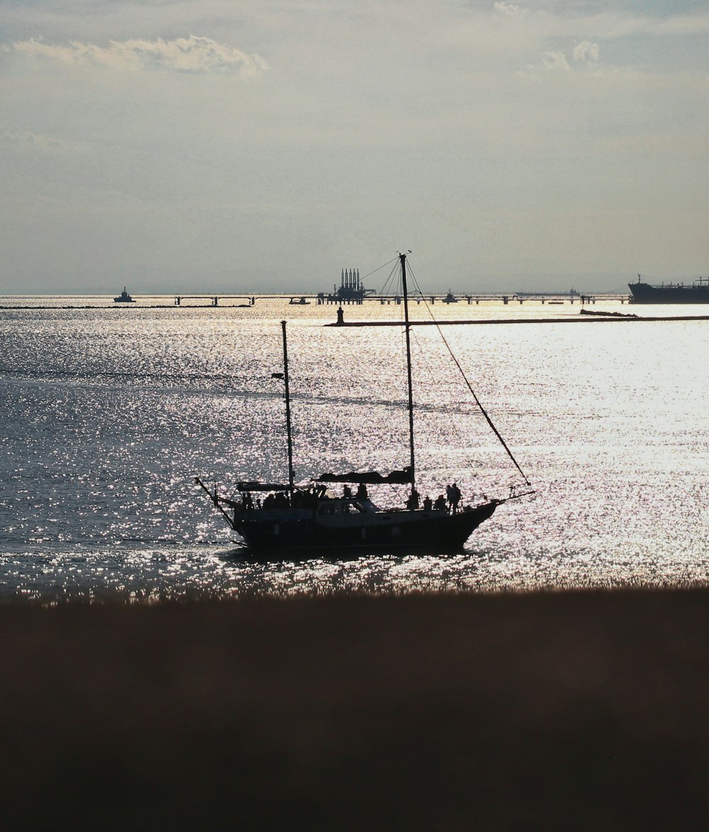 a sailboat in the middle of a body of water