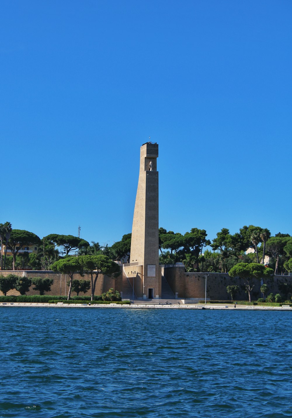 a tall tower sitting on top of a body of water