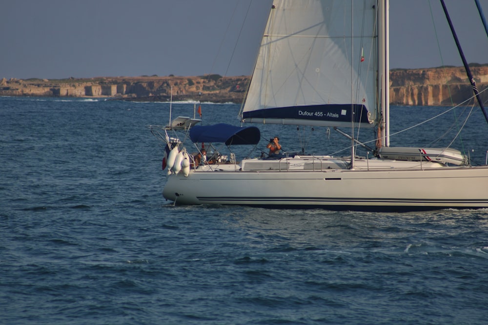 a sailboat sailing on a body of water