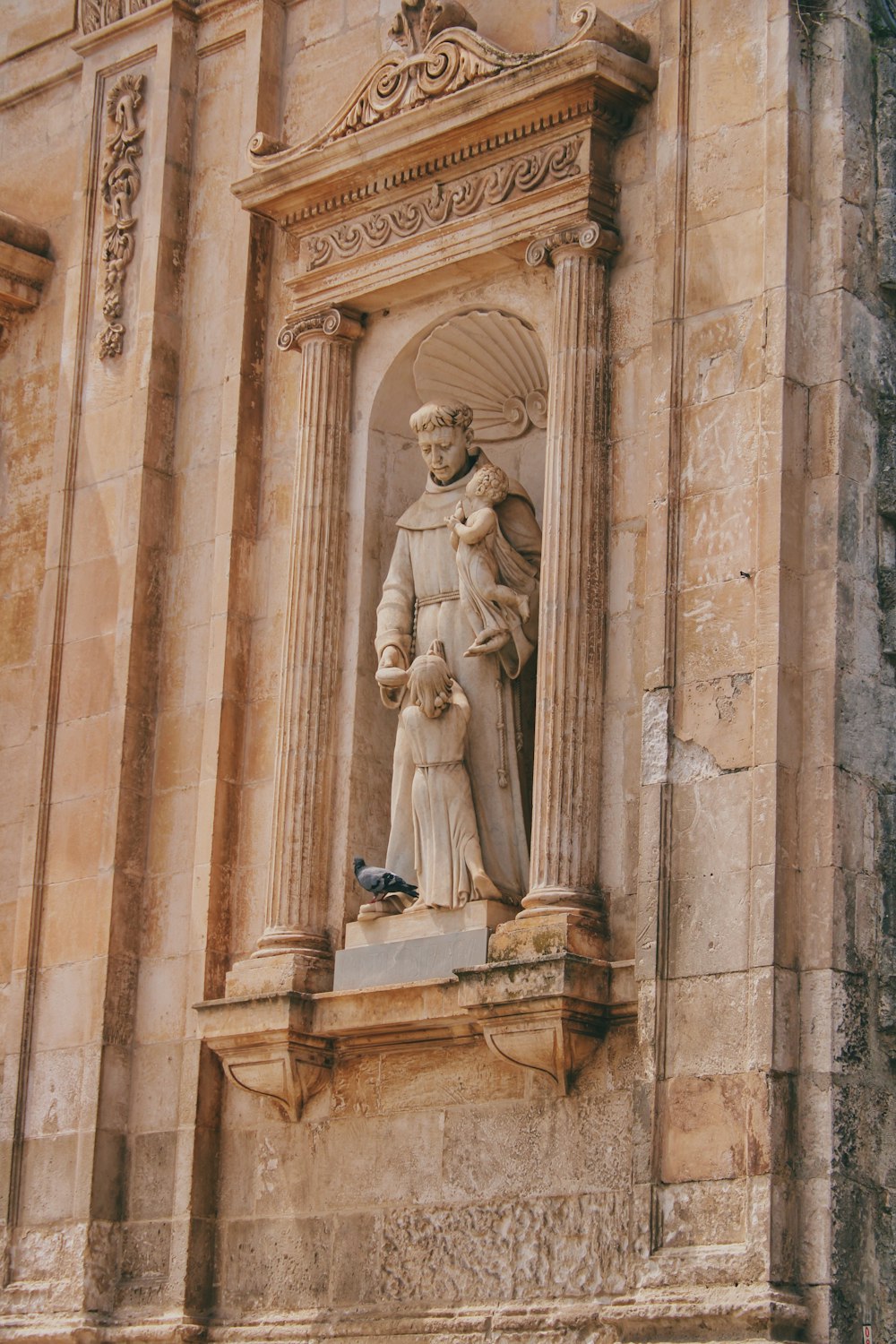 a statue of a woman holding a child