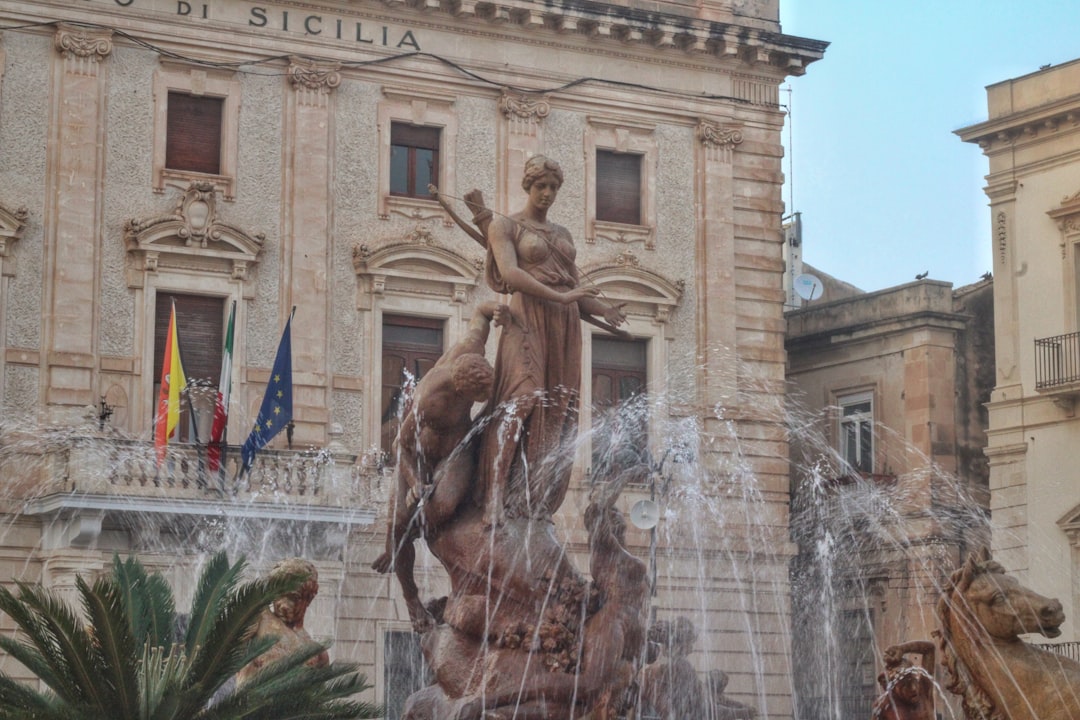 a fountain in front of a large building,
