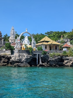 a body of water with a building in the background