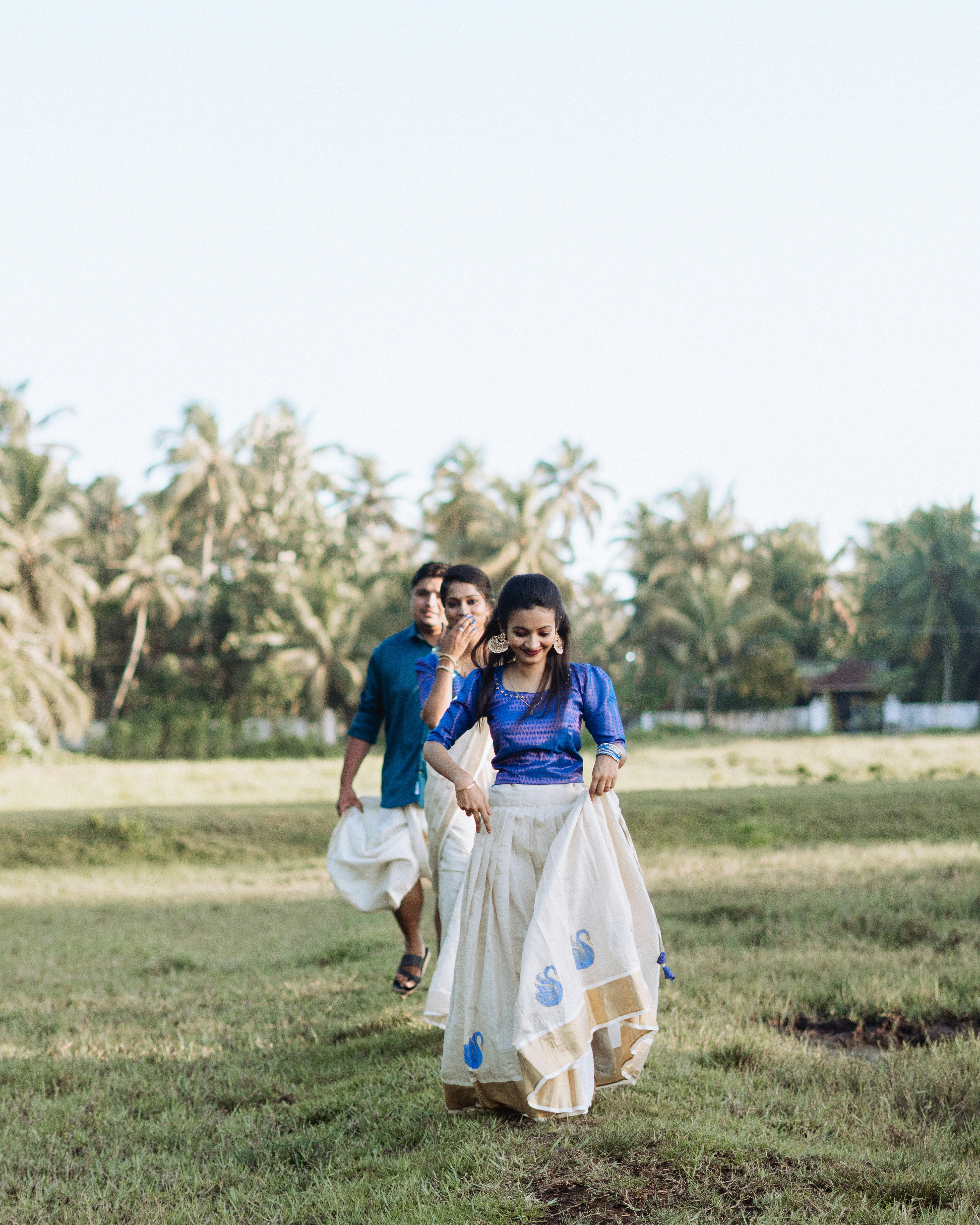 woman wearing yellow long-sleeved dress under white clouds and blue sky during daytime