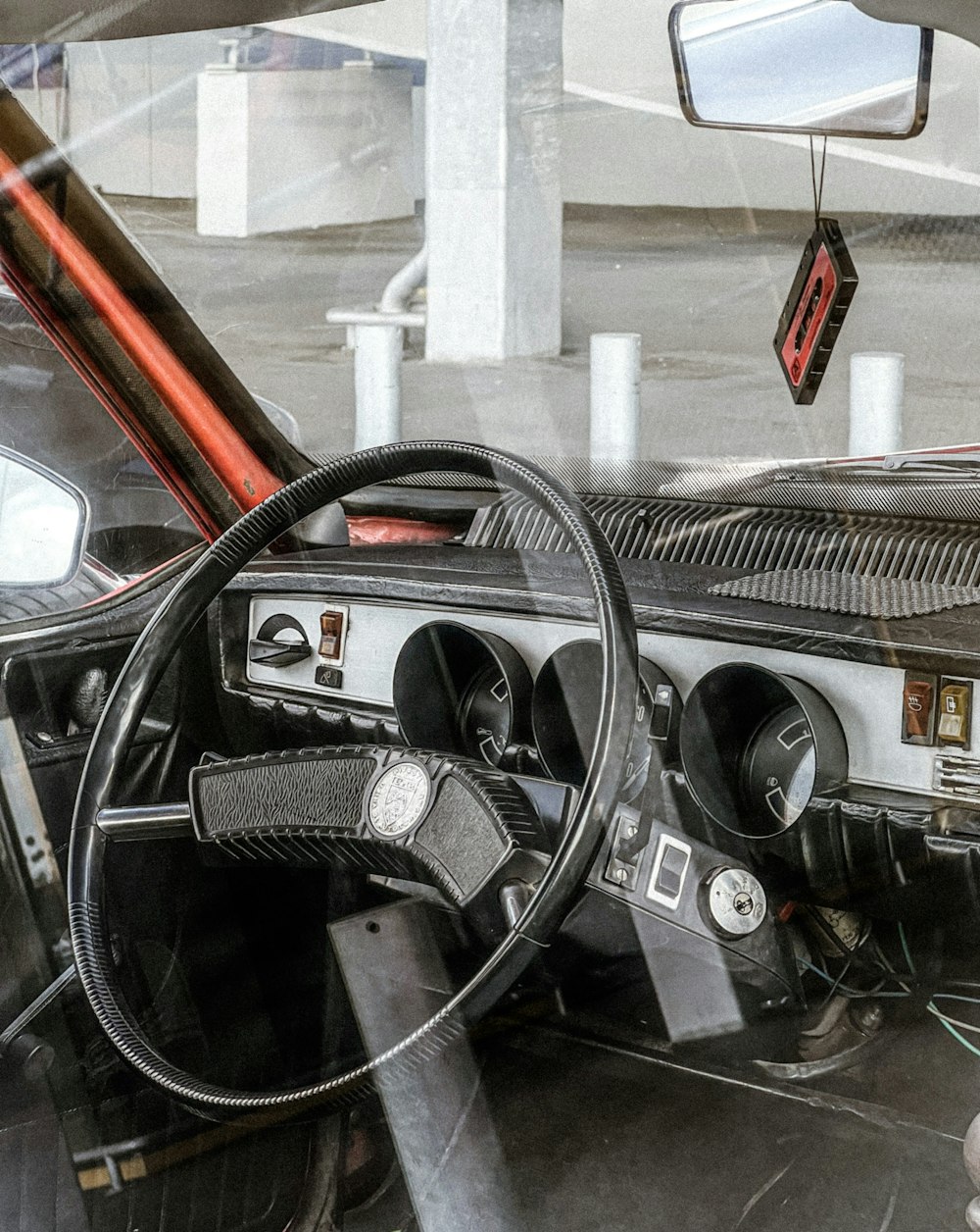 the interior of a car with a steering wheel and dashboard