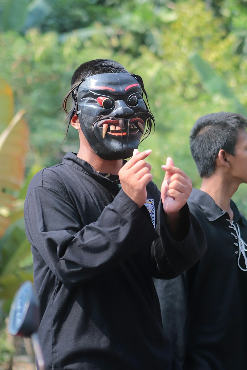 a man with a mask on holding a baseball bat