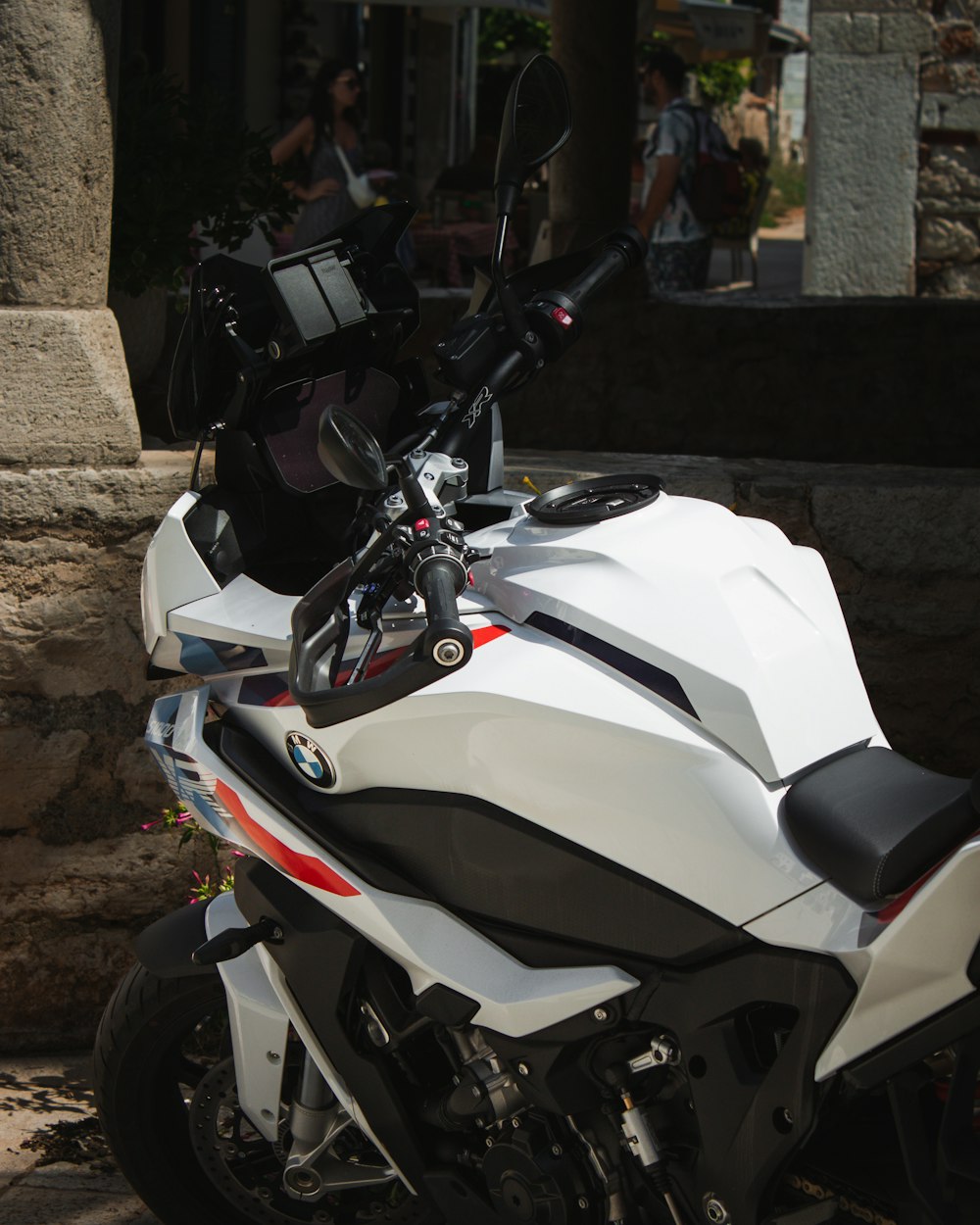 a white motorcycle parked on the side of the road