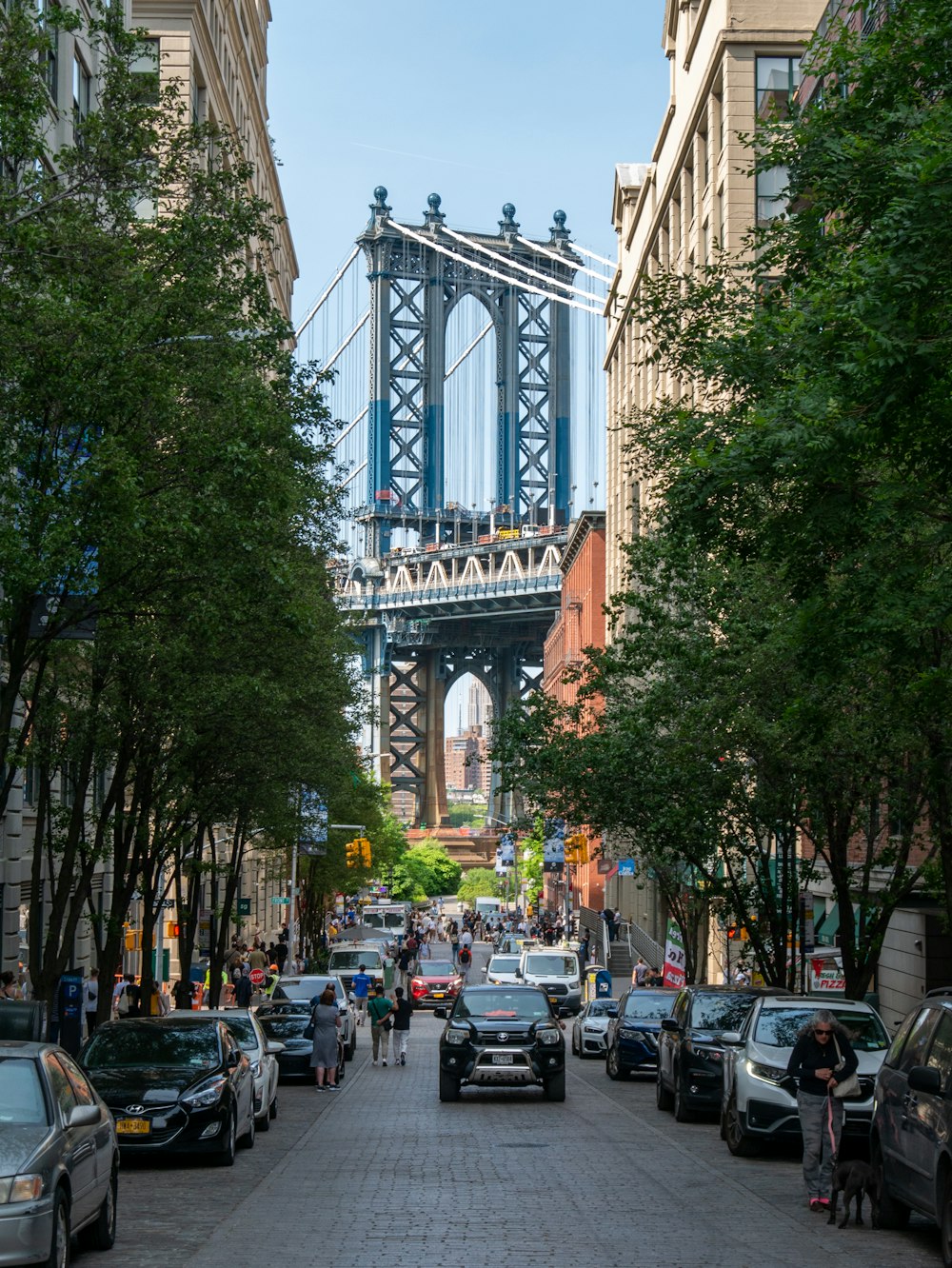 a city street with a bridge in the background