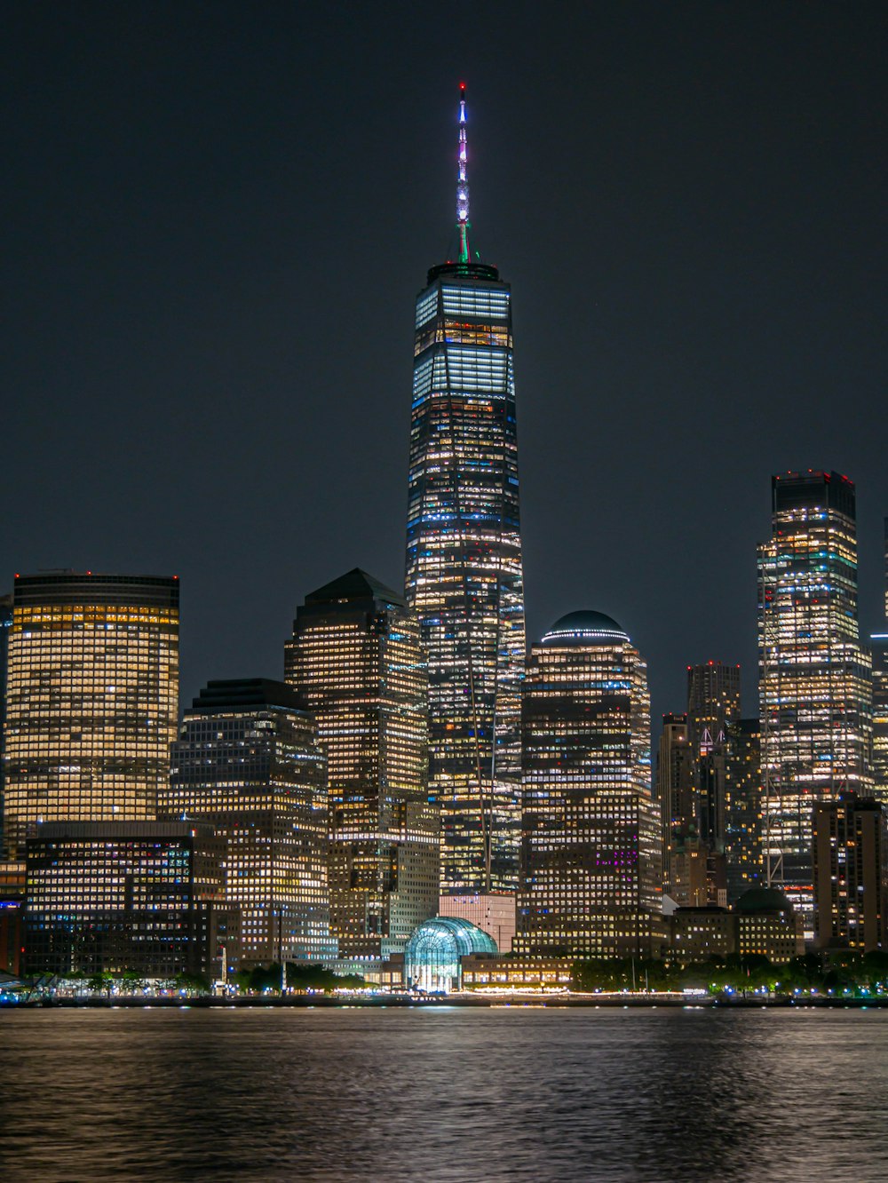 a city skyline at night with the lights on