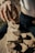 Close-up of hands laying natural stone on a construction site.