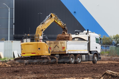 a truck with a load of dirt on the back of it