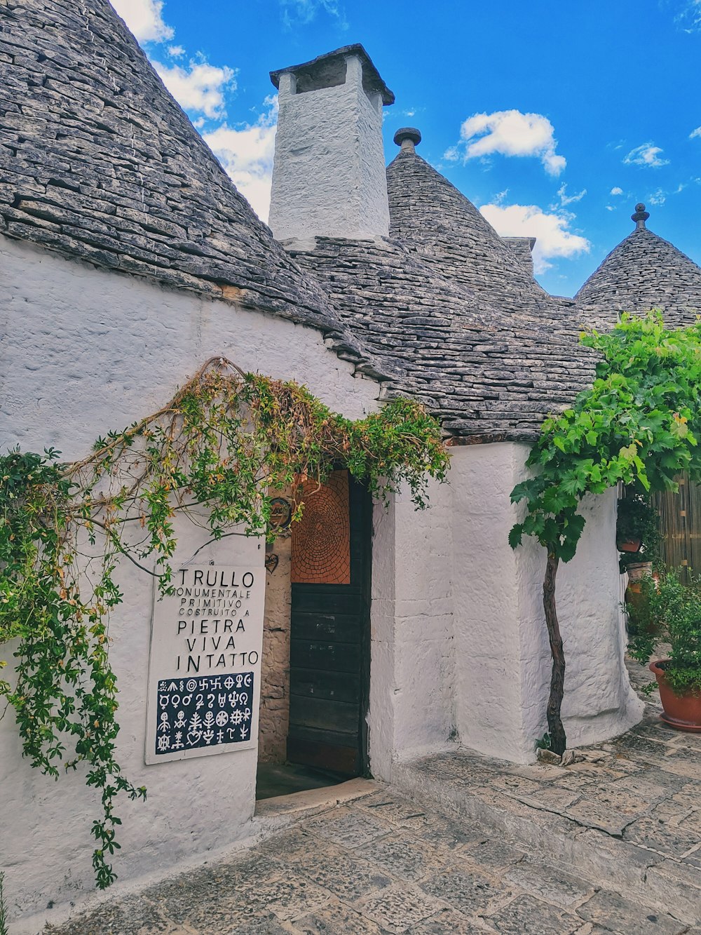 a white building with a black door and a sign