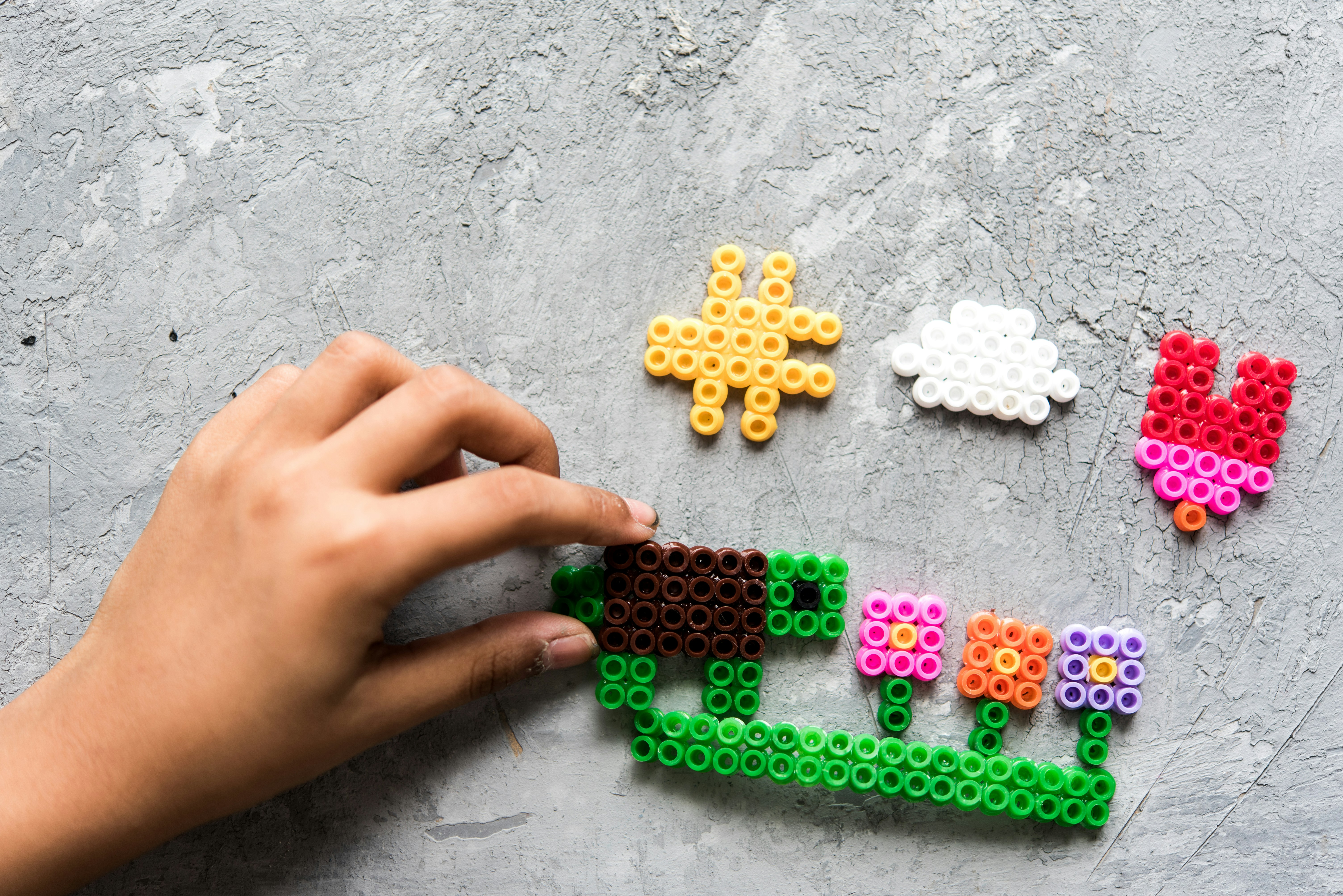 a hand is holding a piece of lego art