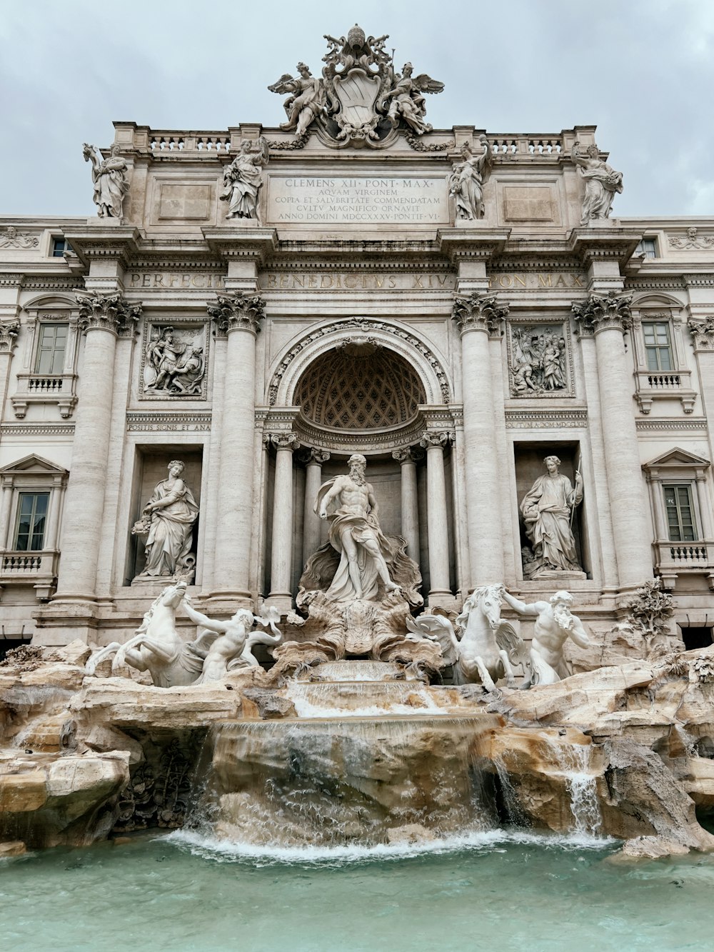 a large building with a fountain in front of it