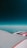 An aerial view showing an airplane wing and engine against a backdrop of the sky. The horizon is visible in the distance, with a gradient from deep blue at the top to lighter shades near the horizon.