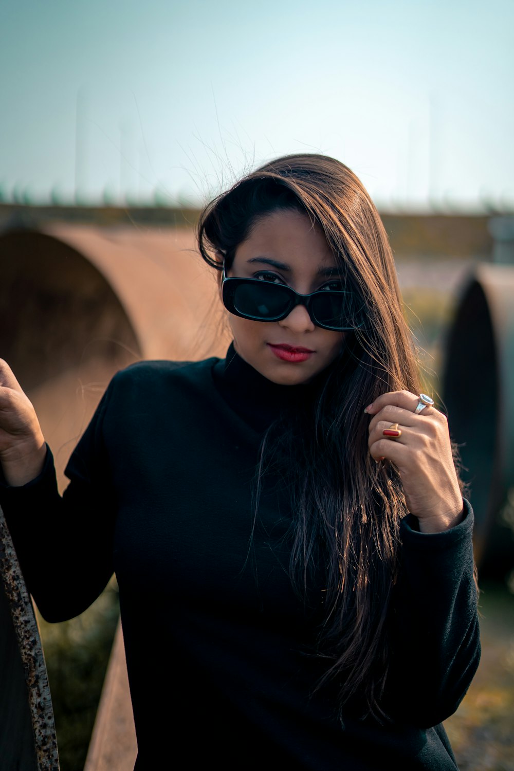 a woman wearing sunglasses and a turtle neck sweater