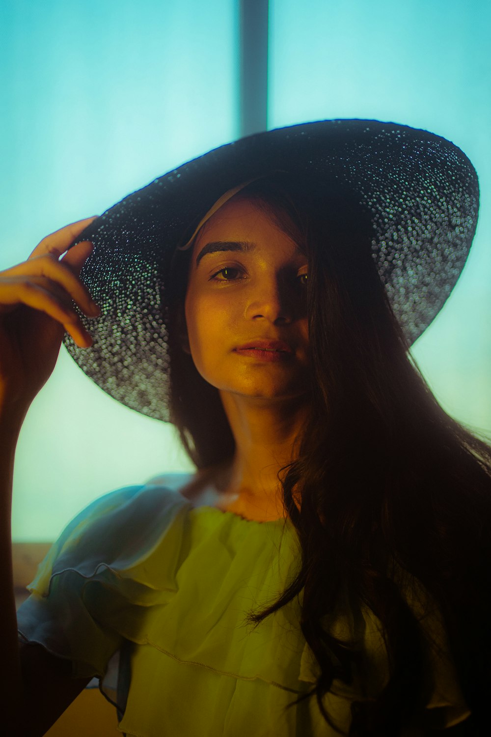 a woman in a hat poses for a picture