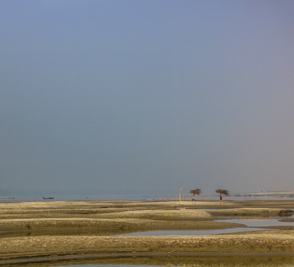 a large body of water sitting under a blue sky