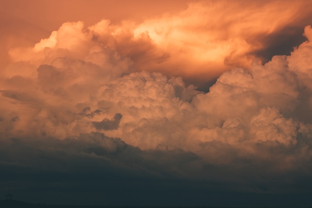 a plane flying in the sky with a lot of clouds