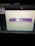 A computer screen displaying a 3D modeling software with the words 'AIC MEDIA' in purple, extruded text. The background is a pale yellow with grid lines visible on the virtual floor.
