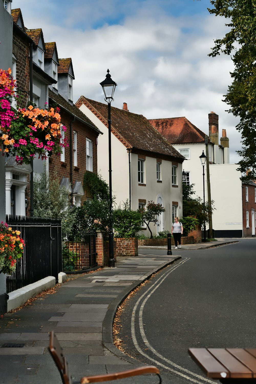 a street lined with houses and a lamp post