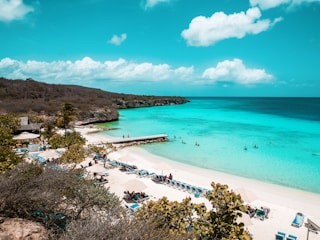 A sunny beach in Alicante with turquoise waters and sunbathers relaxing on the sand