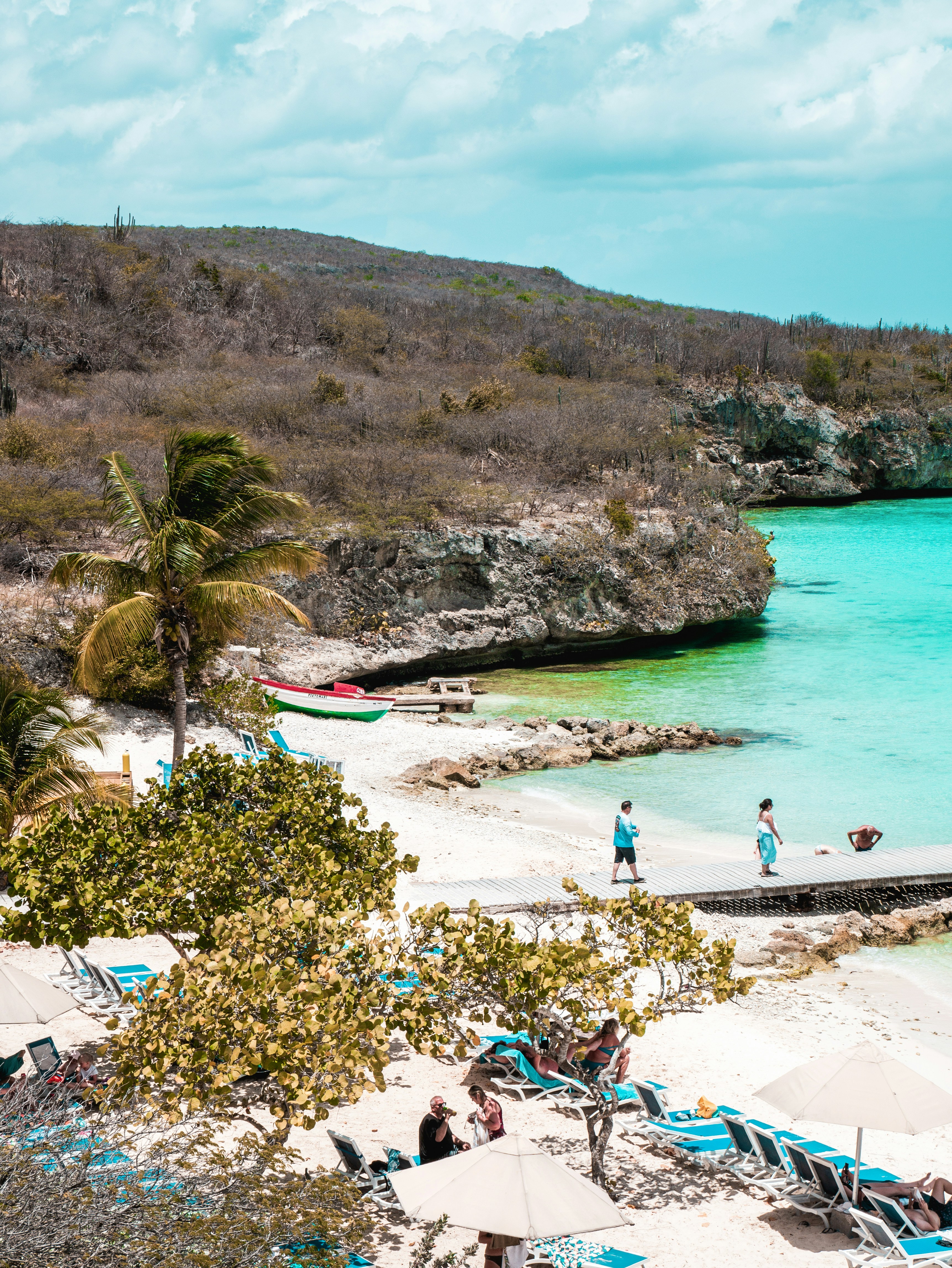 a couple of people that are standing on a beach