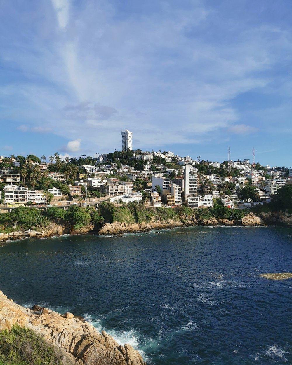 a body of water with a city in the background