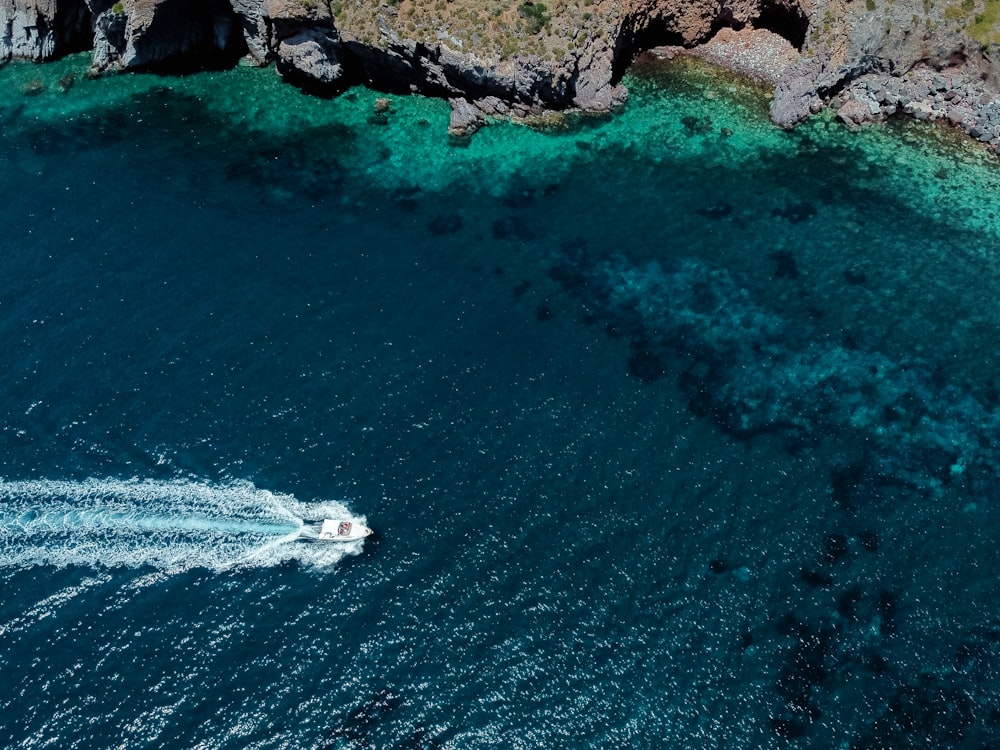 an aerial view of a boat in a body of water