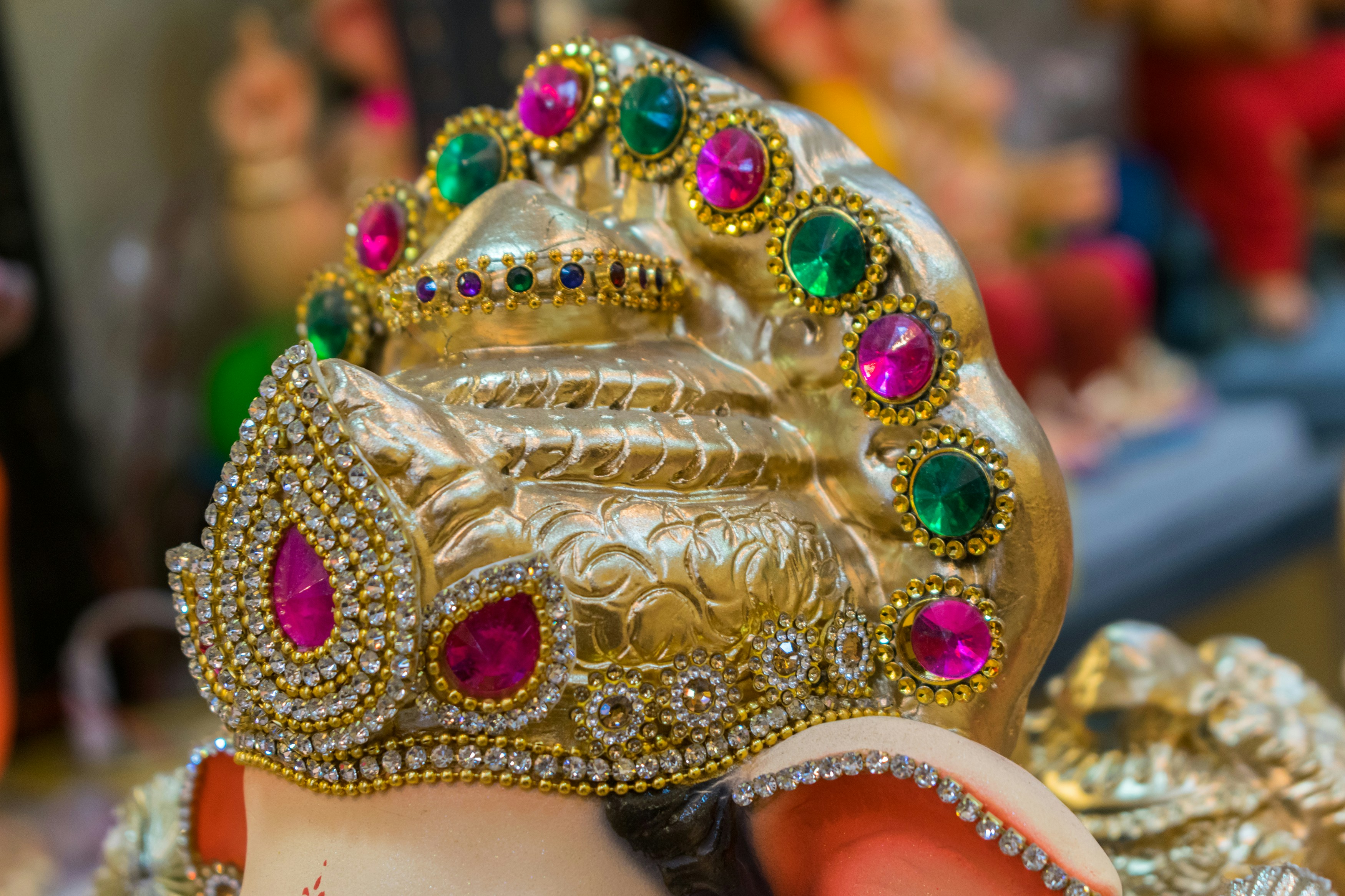 a close up of a statue of an elephant wearing a crown