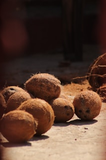 a pile of coconuts sitting on top of a wooden table